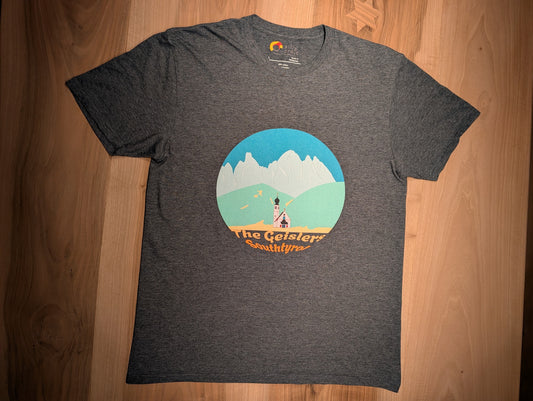 The Geislers t-shirt in dark heather, flat lay on wood – close-up of the Geisler Peaks design