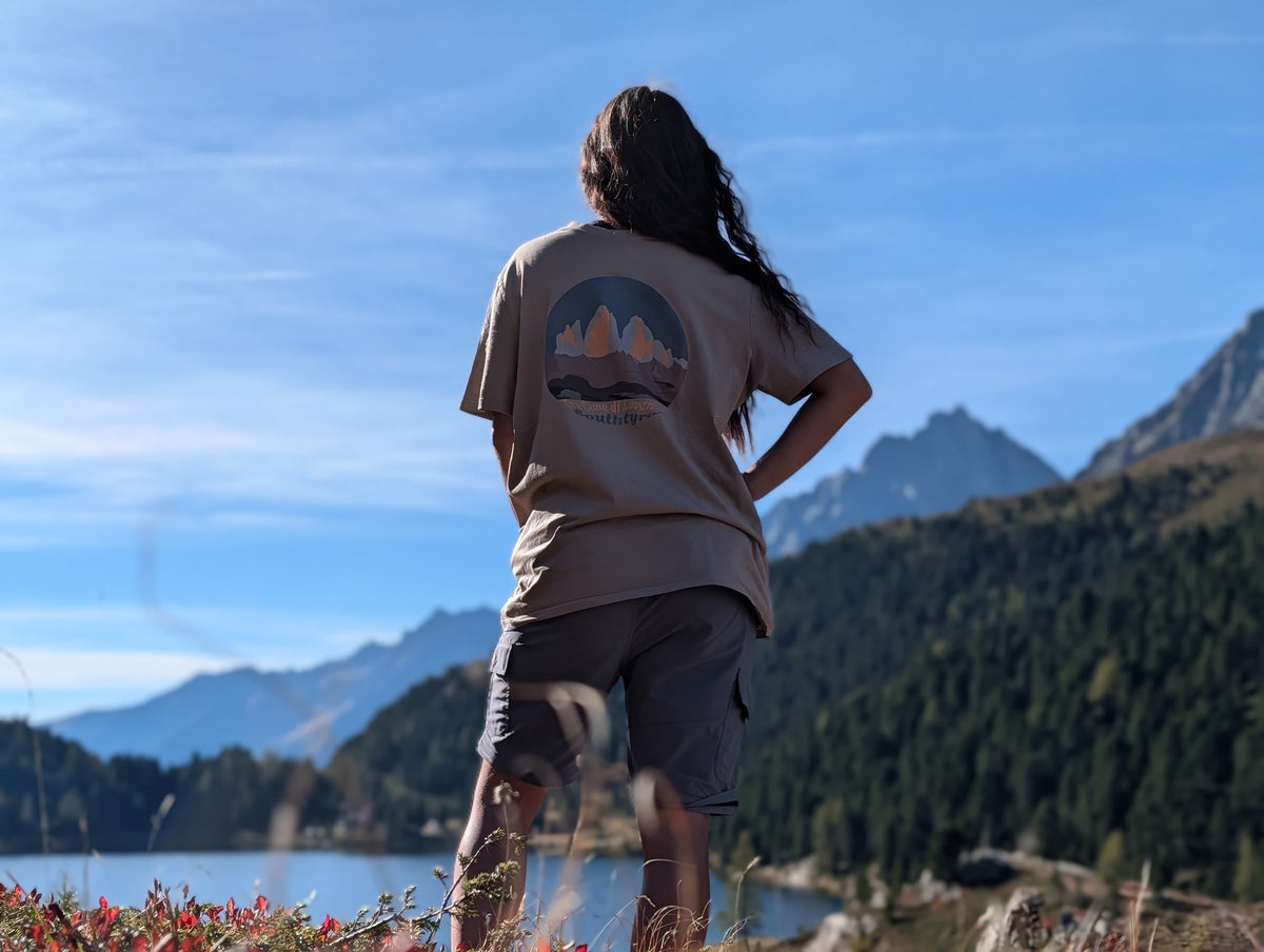 Tre Cime di Lavaredo t-shirt with large back print, worn oversized by her on an autumn hike by an alpine lake
