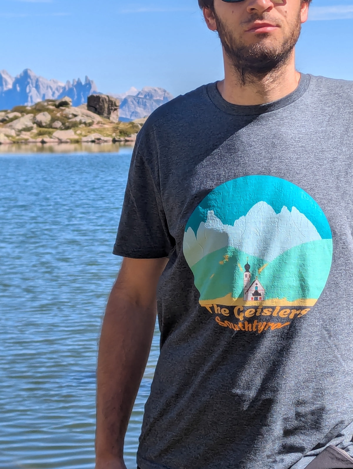 The Geislers men's t-shirt in dark heather worn at an alpine lake in the Dolomites – Silly Craic