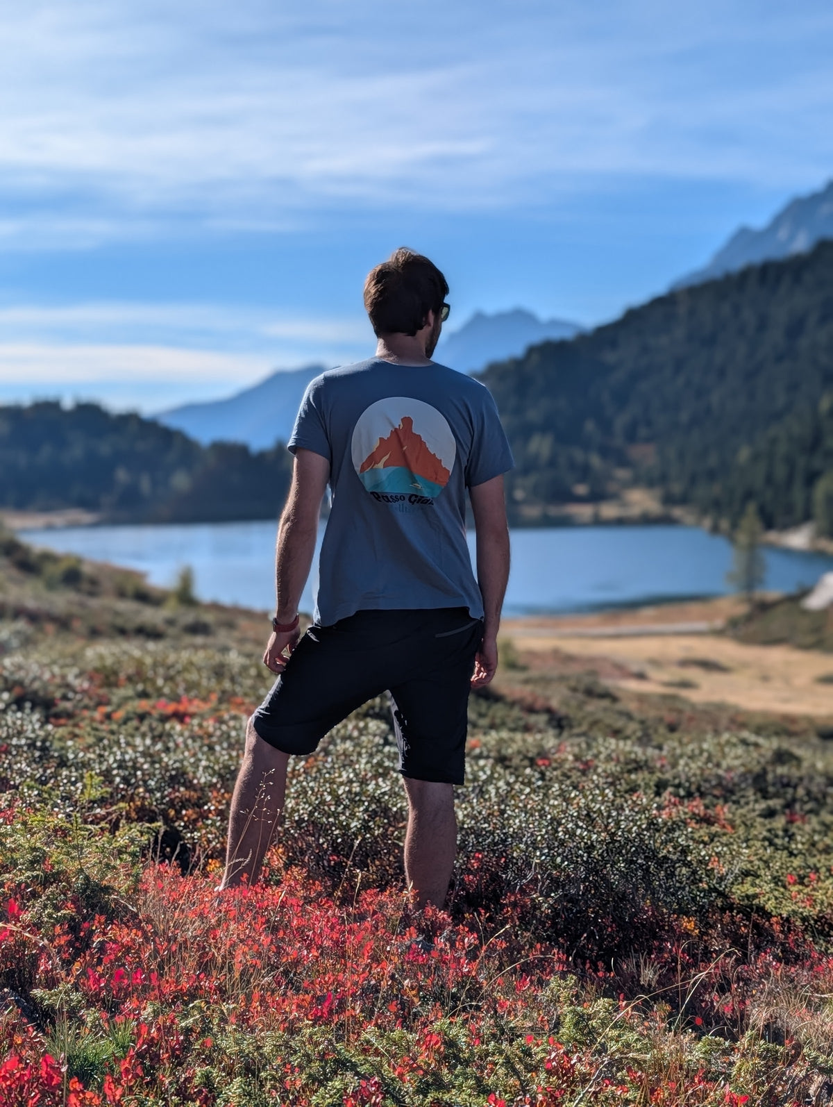 Passo Giau men's t-shirt with large back print, worn on an autumn hike by an alpine lake