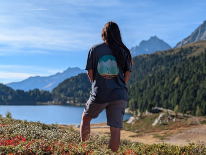 The Geislers t-shirt with large back print, worn oversized by her on an autumn hike by an alpine lake