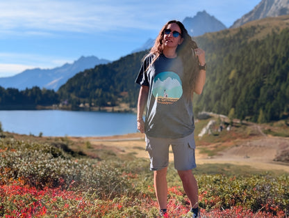 The Geislers t-shirt with front print, worn oversized by her on an autumn hike by an alpine lake