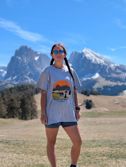 Alpe di Siusi t-shirt worn on the Alpe di Siusi meadows with Sassolungo behind – Silly Craic