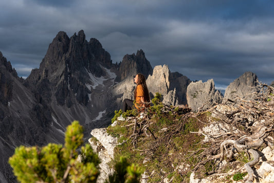 Hiker enjoying the view of the jagged Cadini di Misurina spires in the Dolomites, Italy